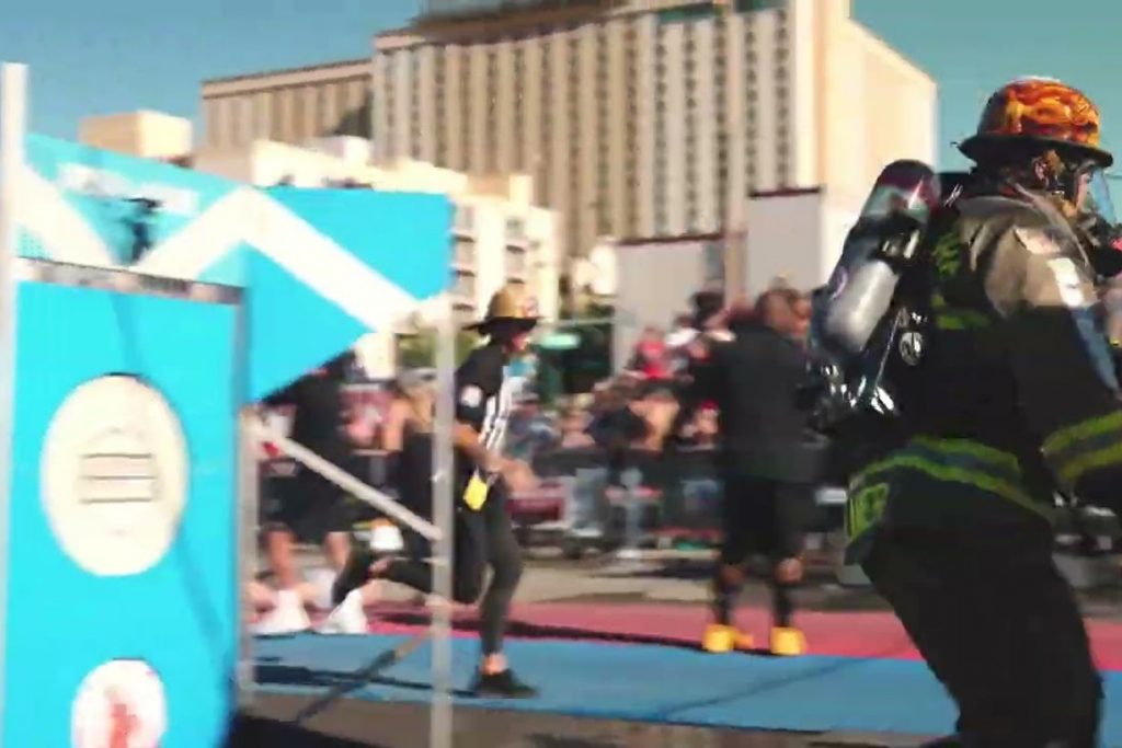 Пожежник у бойовому одязі й шоломі біжить трасою чемпіонату World Firefighter Challenge у Лас-Вегасі